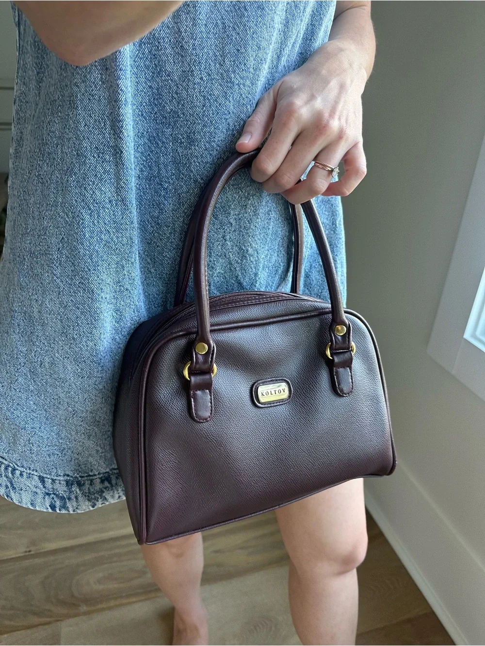 Vintage-inspired burgundy/oxblood structured handbag with gold accents
